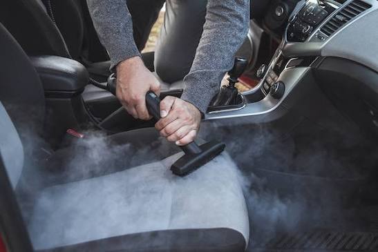 Steam cleaning a car's interior seats